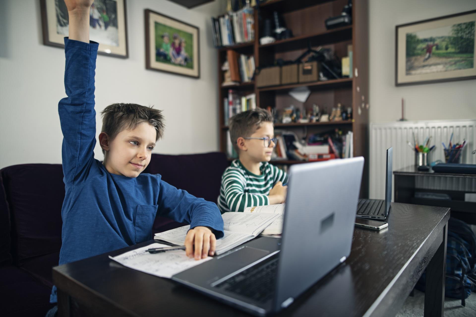 Two elementary students working on laptops. 