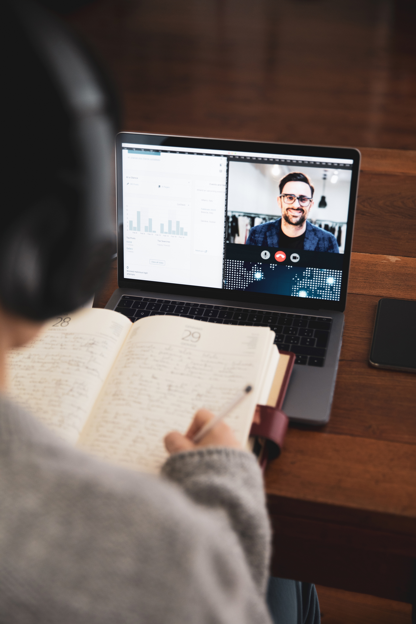 High school student reading while participating in a virtual class.