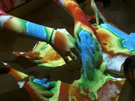 Group of students hands under colorful lights