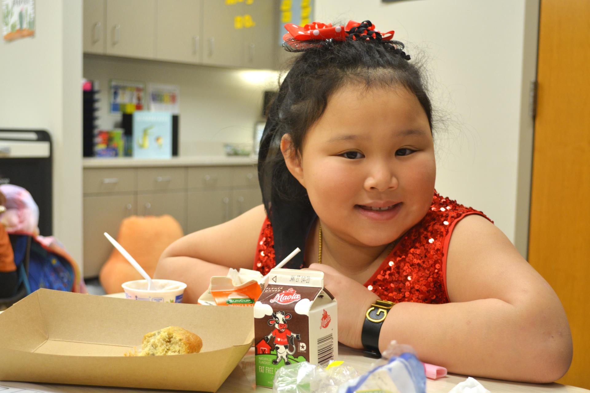 Student eating breakfast in the classroom.