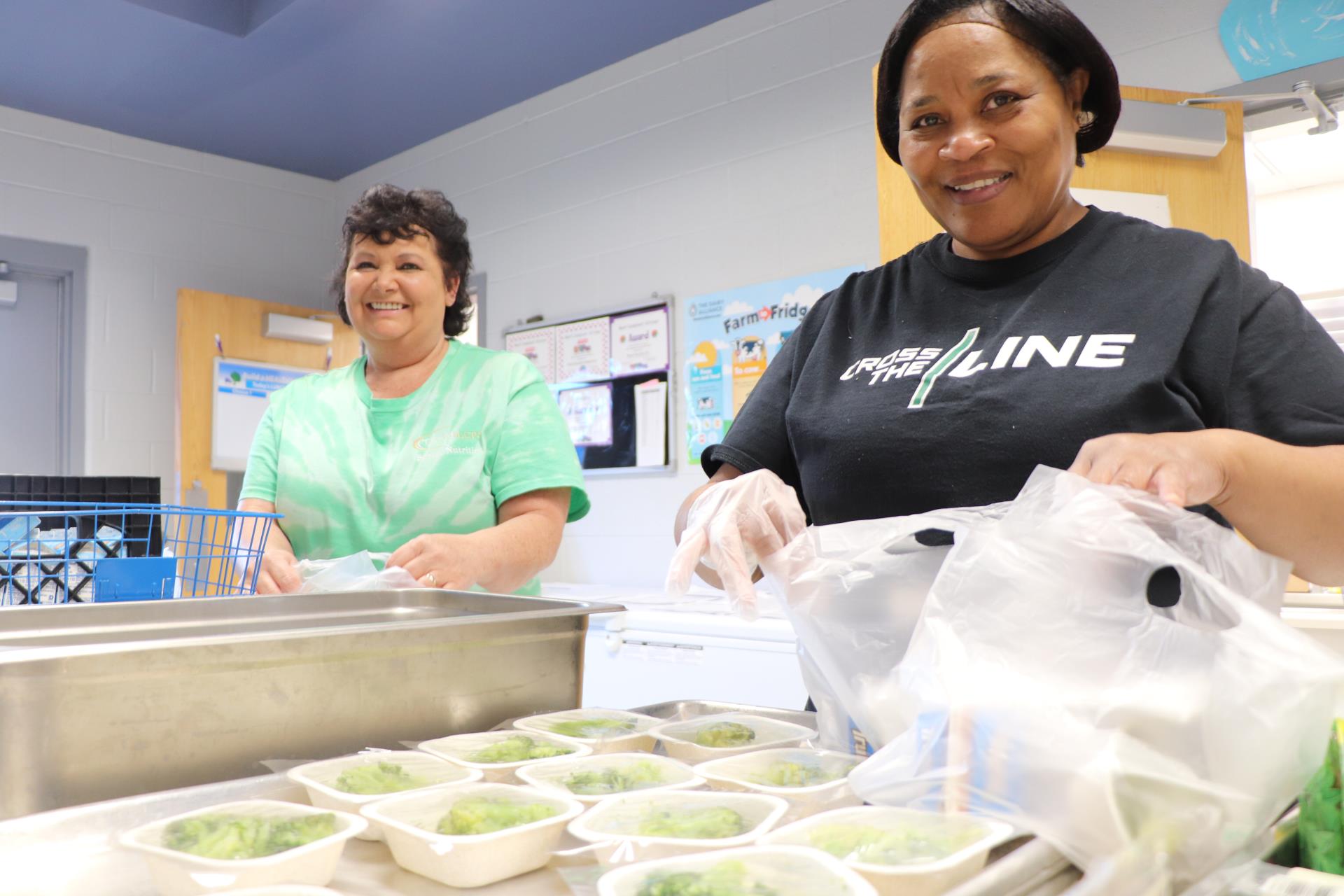 School nutrition professionals pack grab and go breakfast bags.