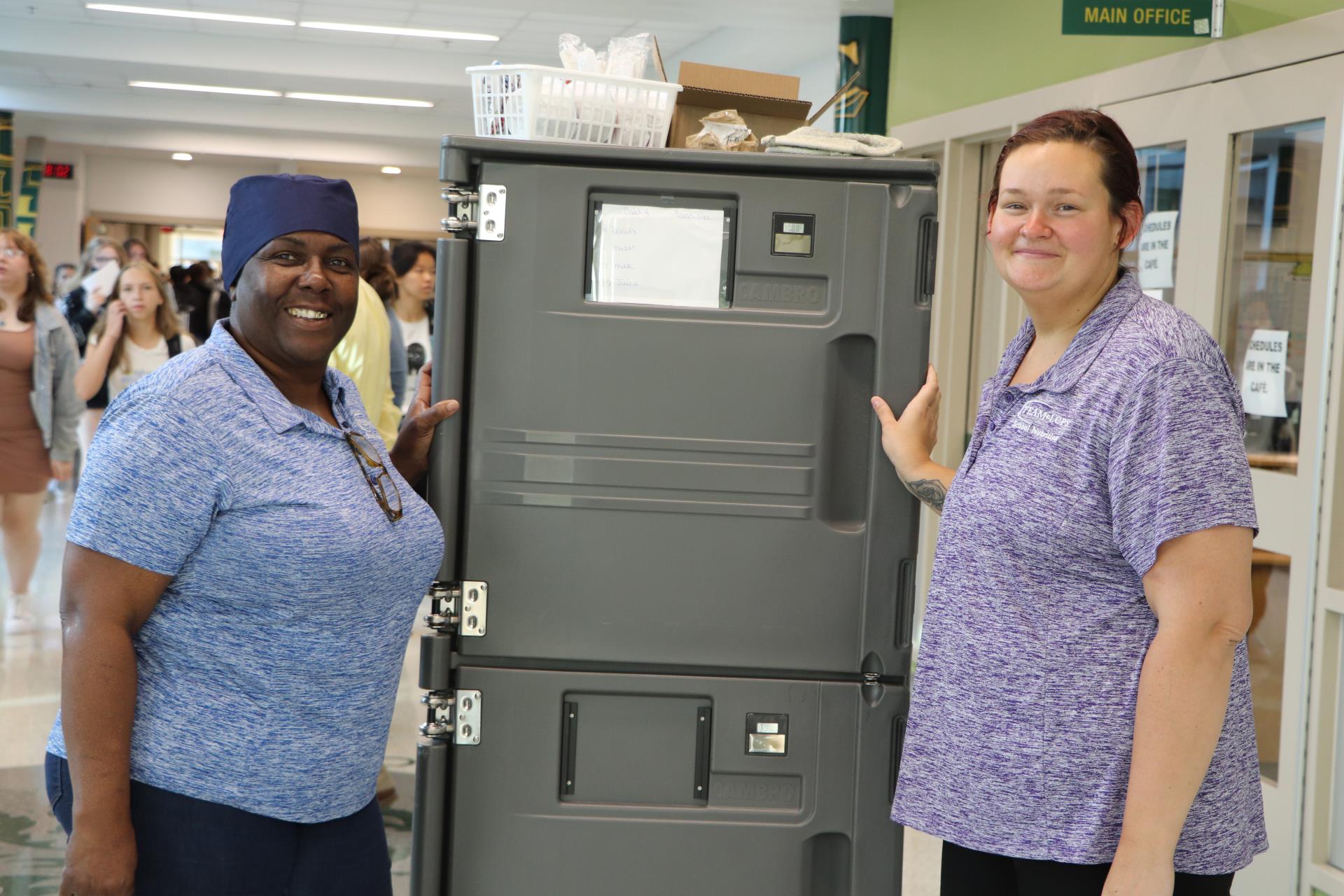 School nutrition professionals deliver breakfasts to the classroom.