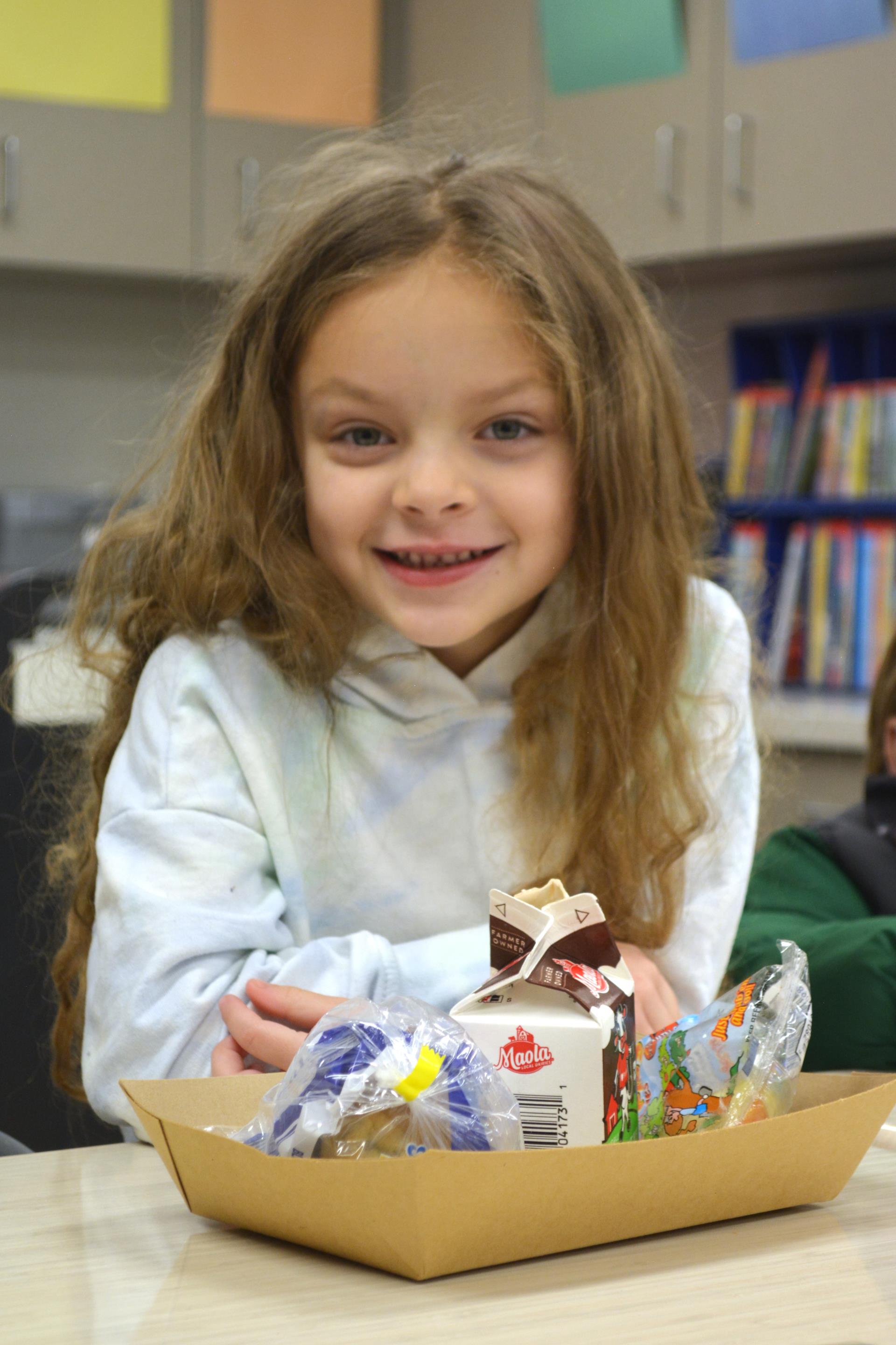 Student eating breakfast in the classroom.