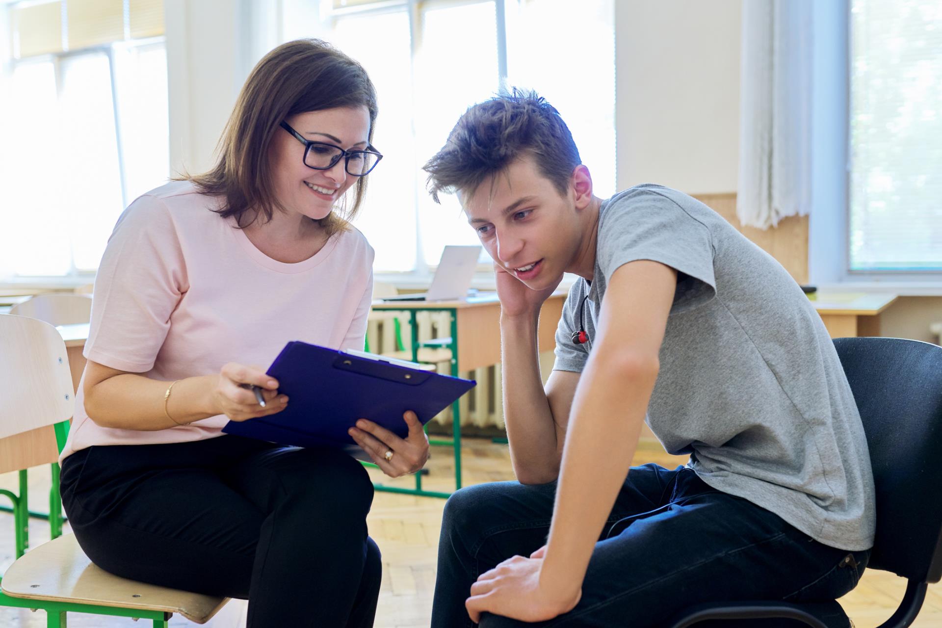 School counselor meeting with high school student.