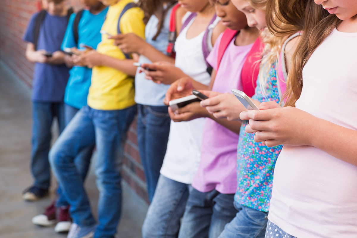 students in line on their cell phones