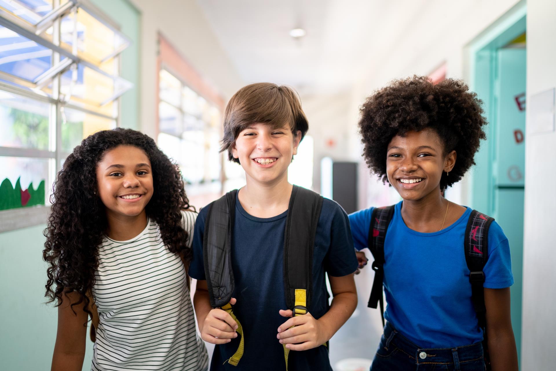 3 smiling middle school students