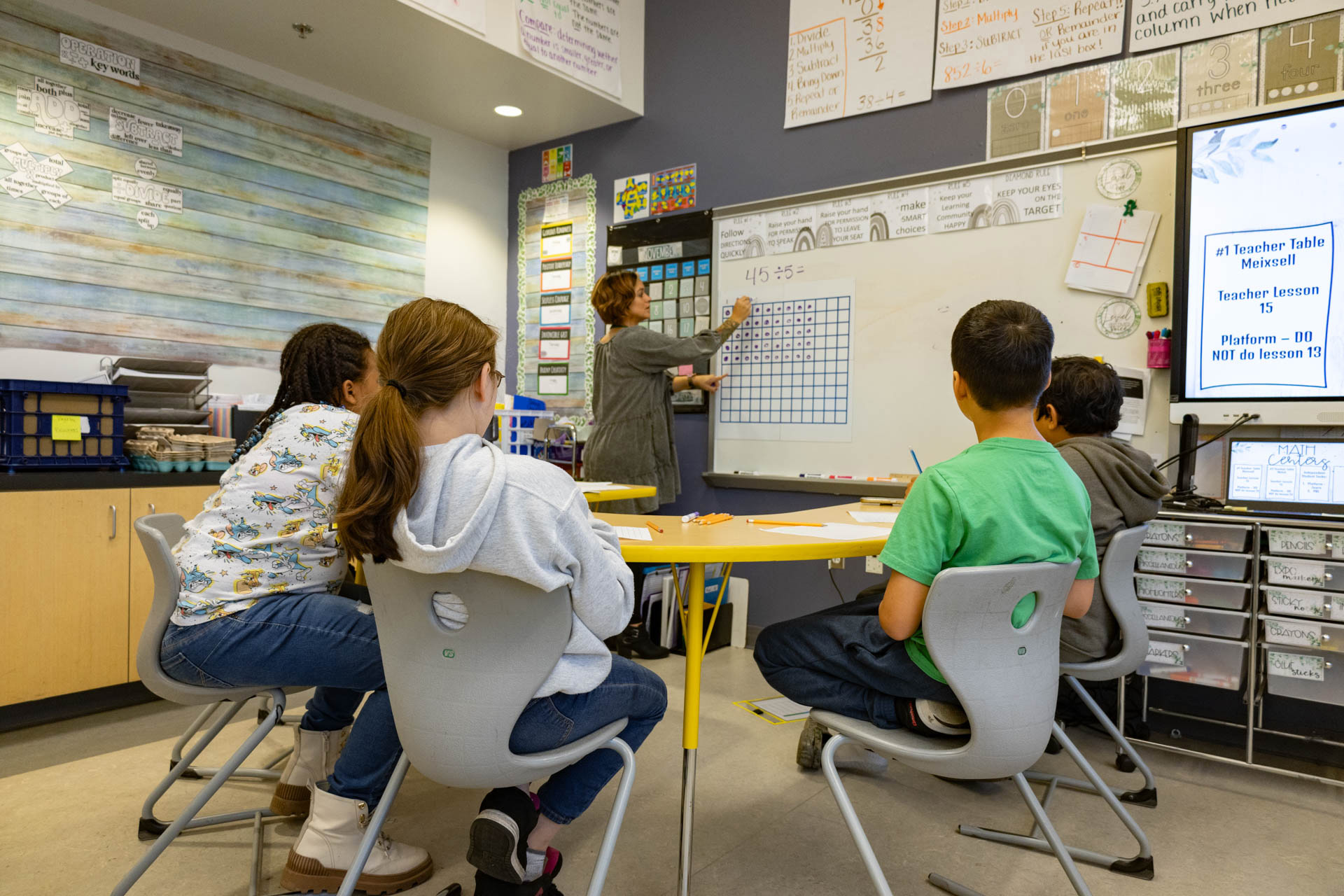 Math teacher works with small group of students.