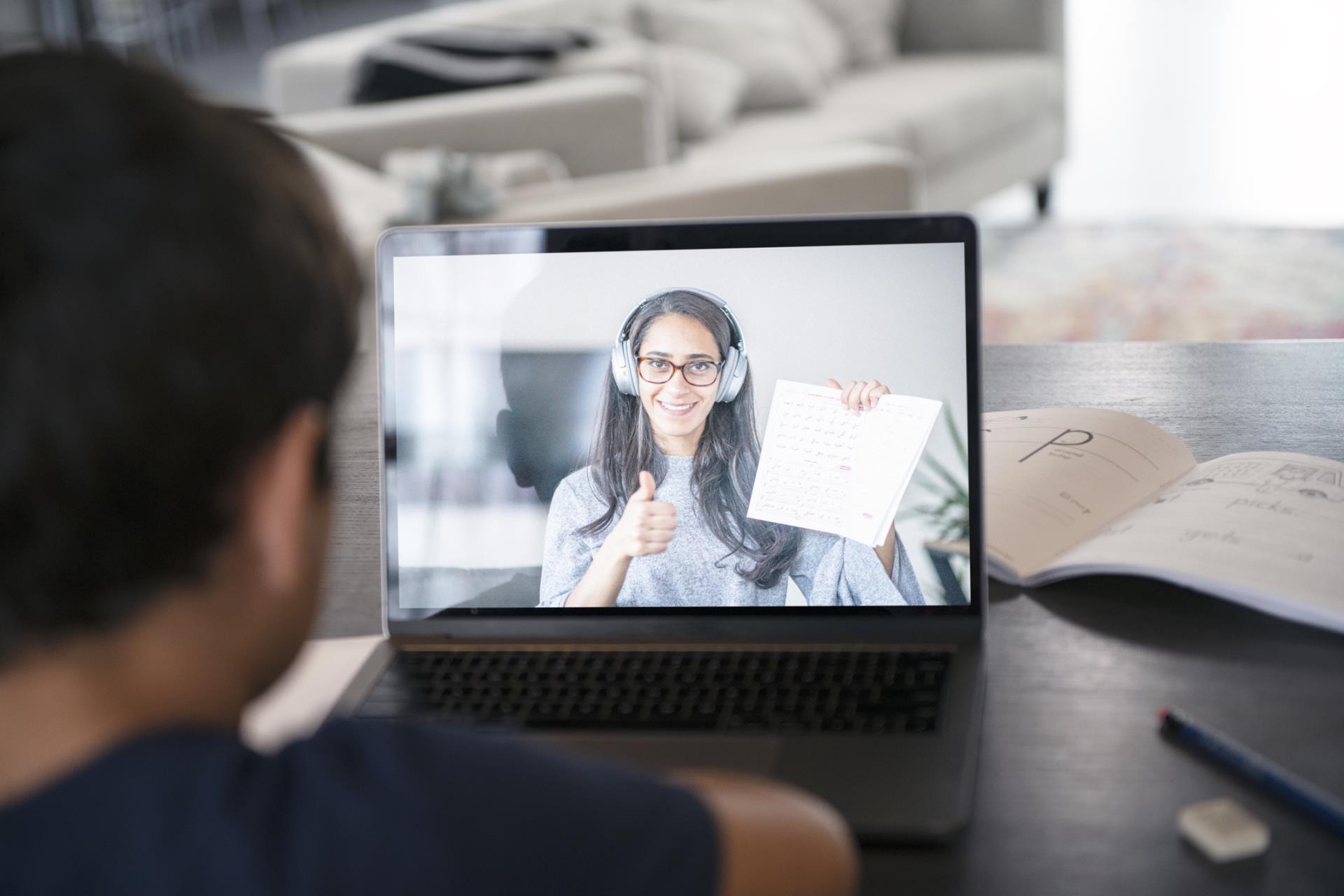 Laptop screen showing a teacher virtually teaching a music class