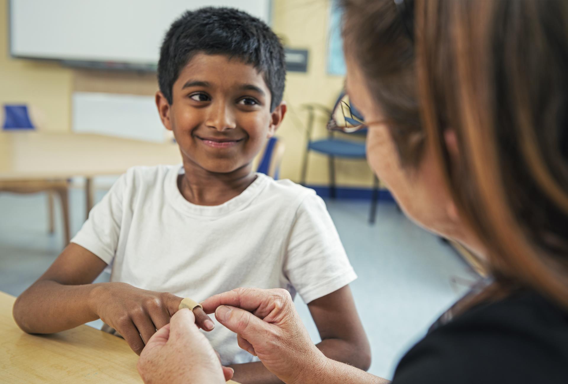 student receiving bandage from school nurse