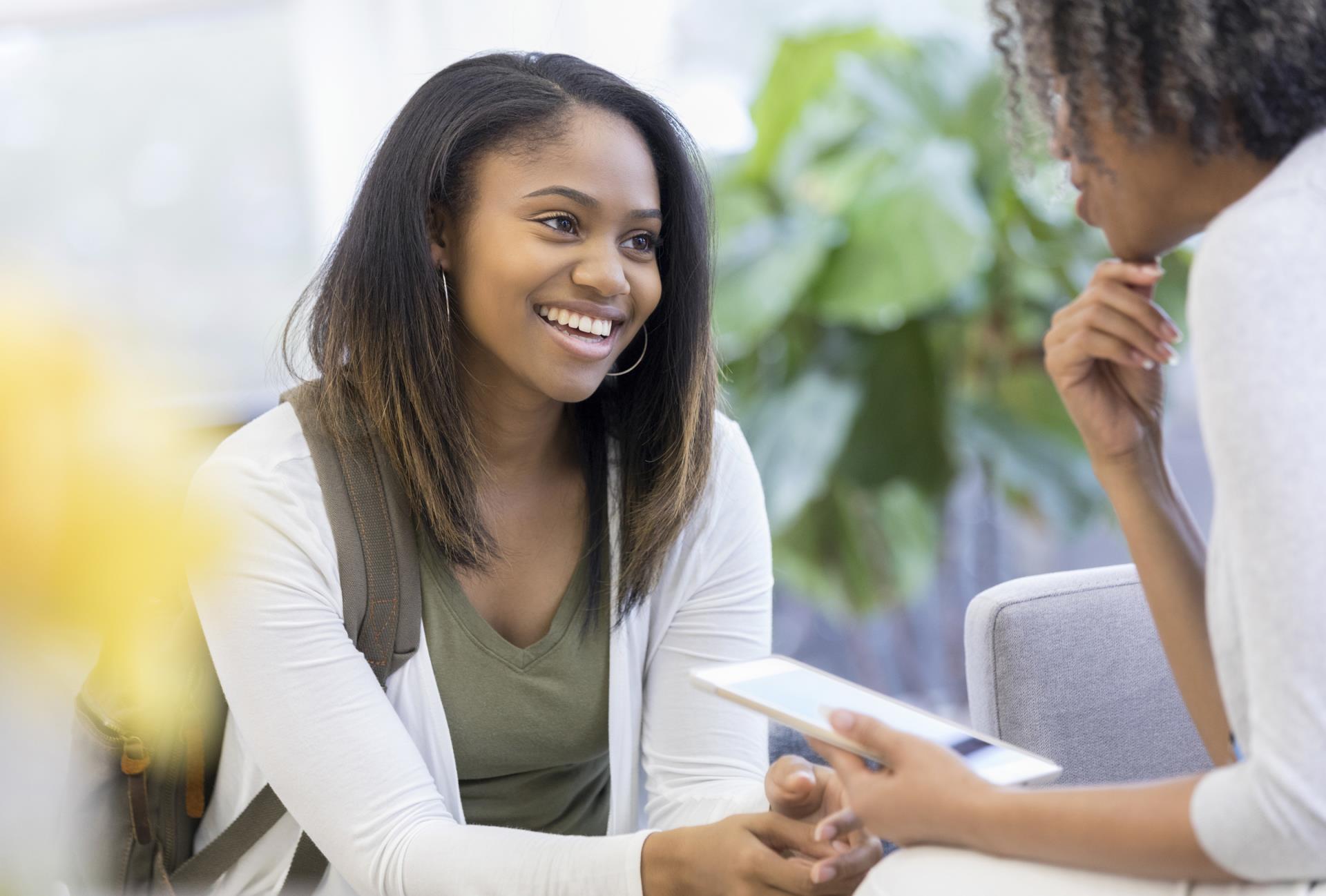 high school student meeting with school counselor